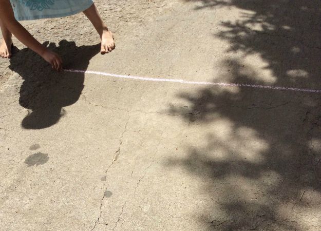 Using sidewalk chalk, draw a line.